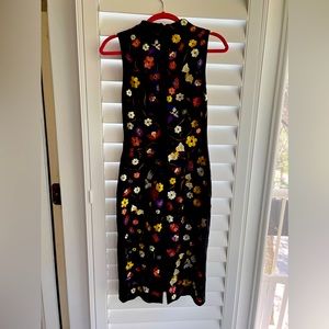 Beautiful embroidery of birds and flowers.  Hugs body nicely.